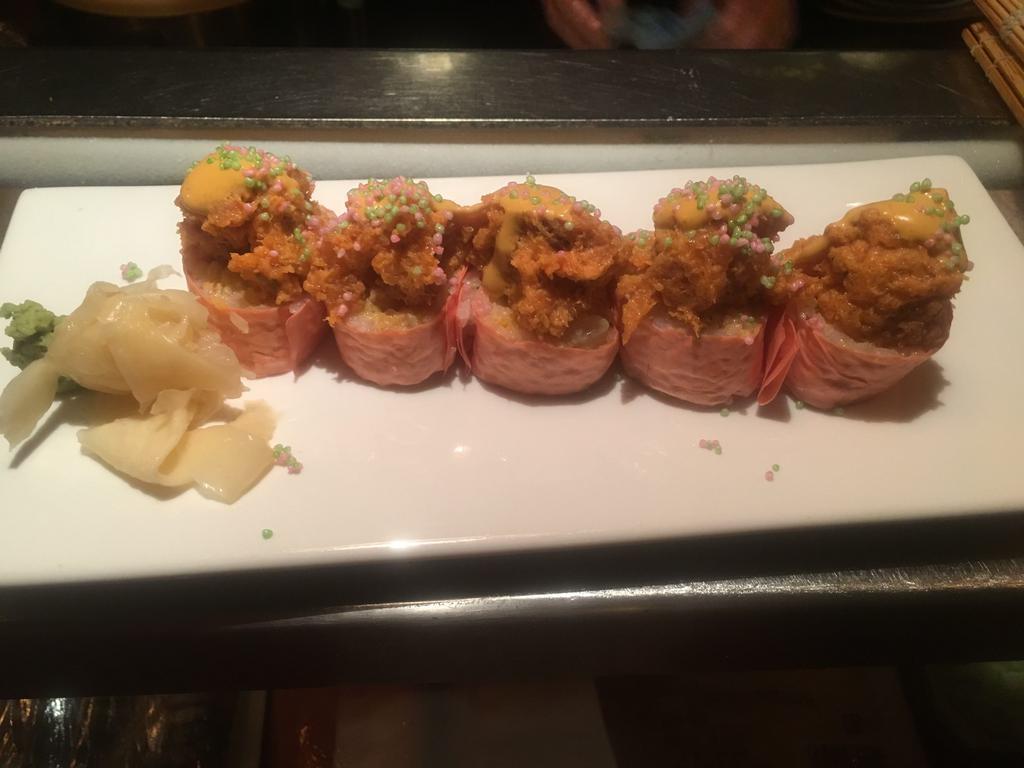 Midtown Roll · Spicy scallop, avocado and tempura flakes wrapped around spicy tuna and rice cracker, wrapped with soy sheet.