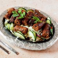 Sheekh Kebab · Ground lamb with onions, herbs and spices grilled on skewer.
