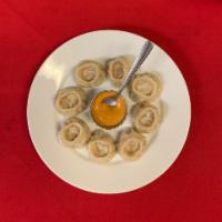 8 Piece Chicken Momo · Steamed dumplings filled with minced chicken, onion, cilantro, and spices. Served with himal...
