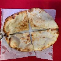 Plain Naan · Traditionally baked bread in the tandoor oven.