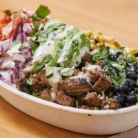 Burrito Bowl · turmeric brown rice, cotija, avocado, black beans, tomato, roasted corn, red onions, cilantr...