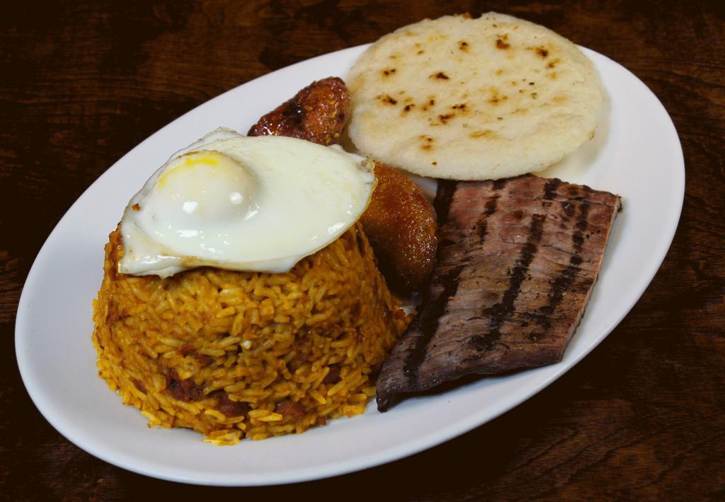 Calentado · Mixed rice and beans, small pieces of pork rinds, fried egg, arepa, and sweet plantains.