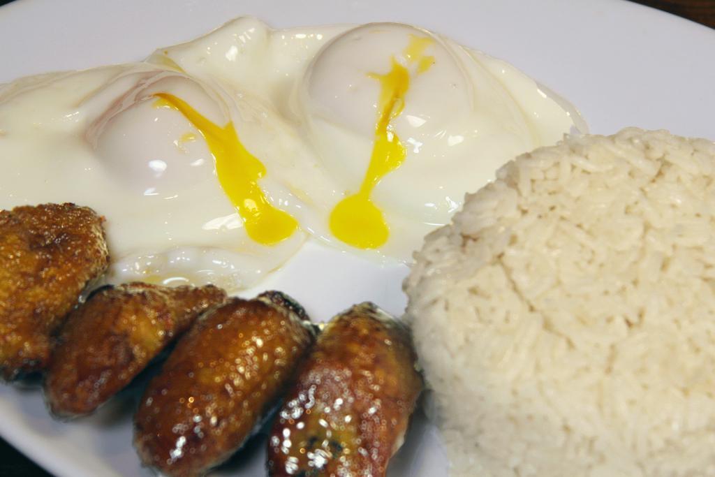 Huevos Fritos and Arroz y Maduros · Fried eggs, rice, and sweet plantains.