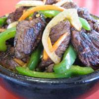 Dragon Beef Bowl · Marinated beef, green peppers, onion and carrots with a spicy soy-sesame sauce over white ri...