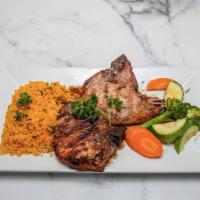 Broiled Pork Chops · Costeletas de porco grelhadas. Served with choice of rice or potatoes and vegetables. 