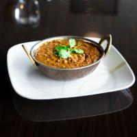 Daal Makhani · Green lentils and black beans slow simmered, lightly sauteed with ginger, garlic and onions.