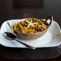 Baingan Bharta · Grilled eggplant pureed and cooked with peas, tomatoes, onions and spices.