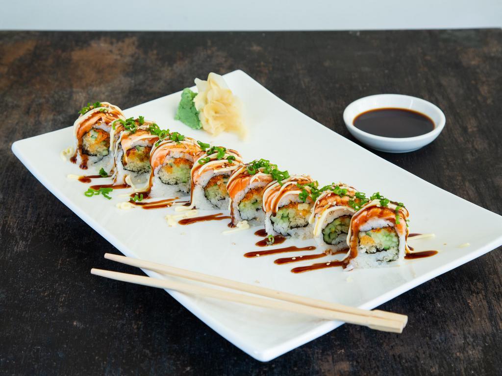 Torched Salmon Maki · Tobiko, cucumber, tempura crumb and spicy mayo topped with torched salmon, eel sauce and regular mayo.