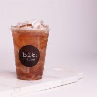 Iced Lychee Peach Black Tea · Black tea, peach syrup, chia seeds and lychee bits.