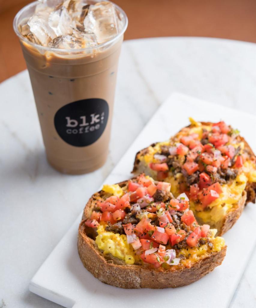 Sausage Egg Toast · Thick country bread, olive oil, house-made pork sausage, scrambled farm egg, cheese, pico de gallo and black pepper.