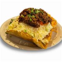 Taco Salad  · Seasoned ground beef over mixed greens with diced tomatoes, green onions, and topped with sh...