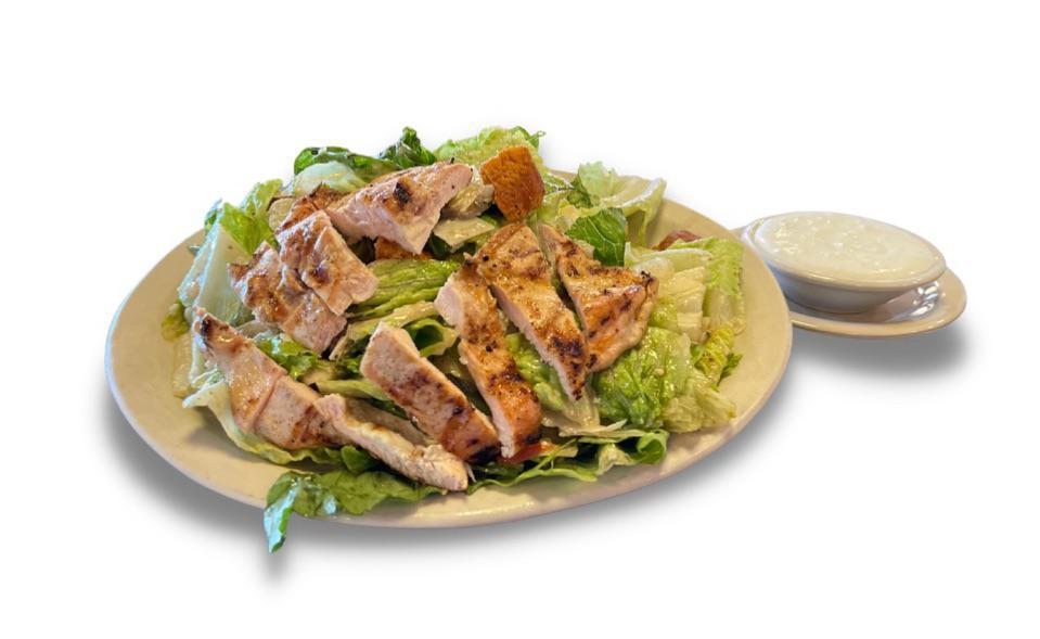 Grilled Chicken Caesar Salad  · Grilled chicken breast over crisp romaine lettuce, mixed with Parmesan cheese, croutons and Norma’s Cafe Caesar dressing. 