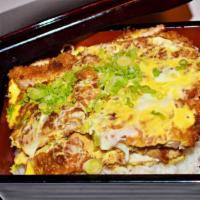 Katsu Don · Pork cutlet, egg and vegetables simmered with sauce over rice.