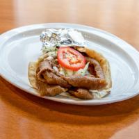 Gyro Sandwich · Lean seasoned meat wrapped in warm pita bread with tomatoes, raw onion and cucumber sauce.