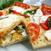 Focaccia Pizza · Thin crust pan pizza, baked with garlic and olive oil, topped with homemade fresh mozzarella...
