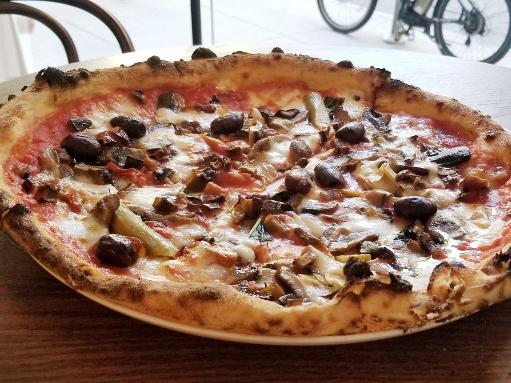 Capricciosa Pizza · Fior di latte, tomato, mushrooms, artichokes, parma ham, olives.