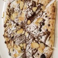 Pizza nutella · Pizza topped with nutella and shaved almonds