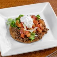Tostada o chalupa · Crispy corn tortilla with your choice of meat, lettuce, tomatoes, sour cream, and beans.