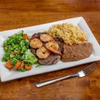 Tequila Ribeye · 8 oz. ribeye topped with 4 shrimps, pico de gallo and queso dip, served with rice and grille...
