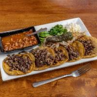 Grandes Tacos · 5 pieces. Asada or pastor, grilled onions, cilantro, cheese, served with sliced avocado and ...