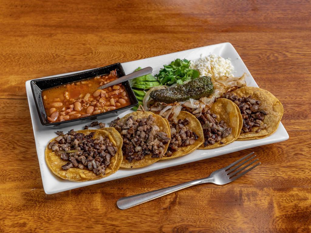 Grandes Tacos · 5 pieces. Asada or pastor, grilled onions, cilantro, cheese, served with sliced avocado and charro beans.