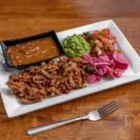 Carne al Pastor · Diced pork in a special sauce, charro beans, guacamole, pico de gallo, and spicy salad.
