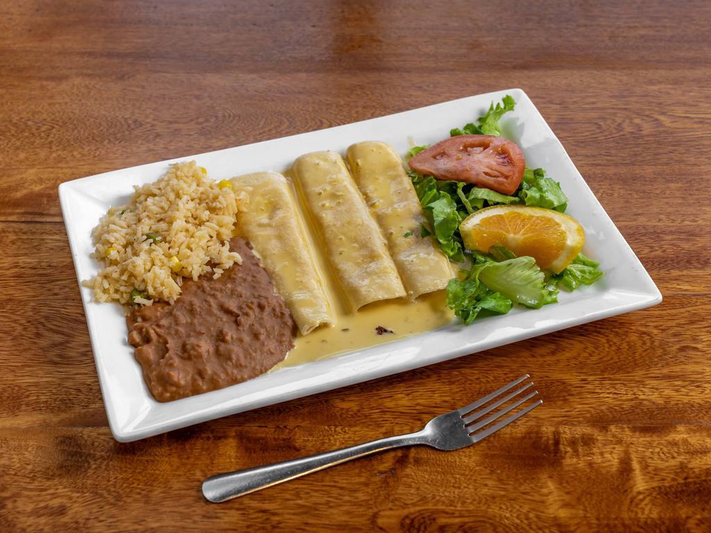 Queso Dip Enchiladas · 3 cheese, chicken or ground beef enchiladas, and covered with queso dip.