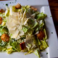 Caesar Salad · Crispy Romaine Lettuce, garlic croutons, shaved Parmesan cheese, homemade Caesar dressing.