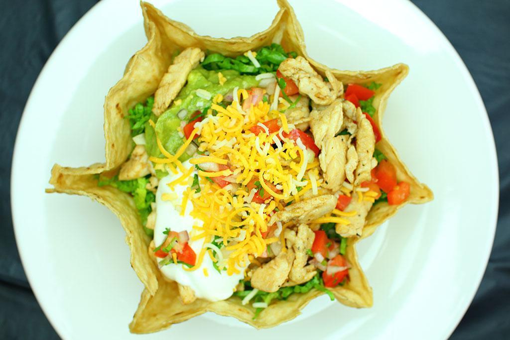 Taco Salad · Tortilla shell with beans, lettuce, guacamole, sour cream, cheese, pico de gallo and your choice of meat