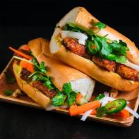 Tofu Banh Mi · Vietnamese baguette, sweet braised tofu, edamame pate, cucumber, pickled carrots and daikon,...