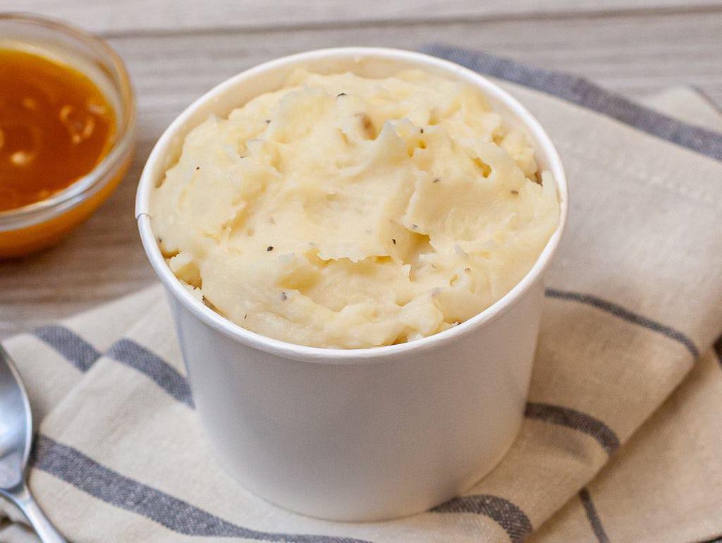 Mashed Potatoes & Gravy · Only the good stuff goes in here: real potatoes, milk, butter, and cracked black pepper. It’s whipped until soft, creamy, and silky smooth.