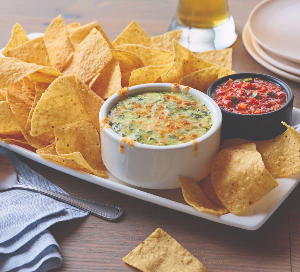 Spinach and Artichoke Dip · Topped with melted Parmesan, and served with white corn tortilla chips and chipotle like salsa.