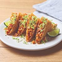 Chicken Wonton Tacos · Spicy chicken-stuffed wonton shells, slaw and cilantro. 