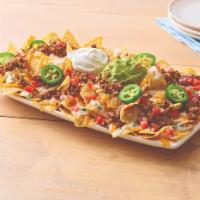 Neighborhood Nachos with Beef · White corn tortilla chips, topped with taco seasoned ground beef, queso blanco, a blend of C...