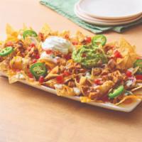 Neighborhood Nachos with Chicken · White corn tortilla chips, topped with chipotle lime chicken, queso blanco, a blend of Chedd...