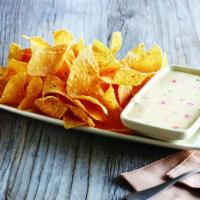 White Queso Dip and Chips  · Freshly made white corn tortilla chips and white queso dip.