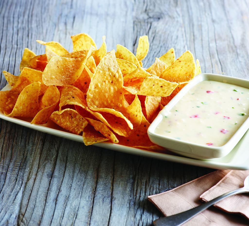 White Queso Dip & Chips · Melty white queso served with freshly made white corn tortilla chips. Gluten-sensitive.