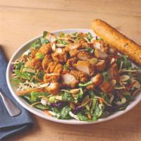 Oriental Chicken Salad · A long-running favorite. Crispy breaded chicken tenders top a bed of Asian greens, rice nood...