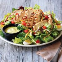 Grilled Chicken Salad · Grilled chicken on a bed of fresh greens topped with a blend of Cheddar cheeses, grape tomat...