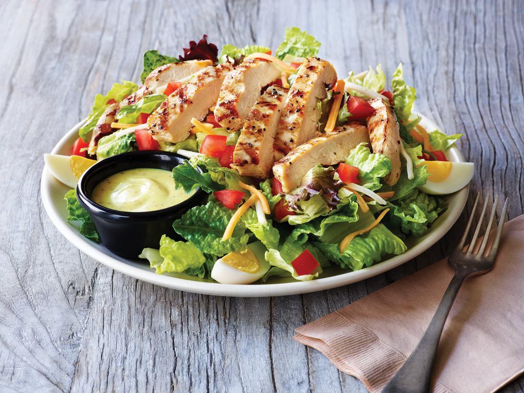 Grilled Chicken Salad · Grilled chicken on a bed of fresh greens topped with a blend of Cheddar cheeses, grape tomatoes and a hard-boiled egg. Served with choice of dressing and a golden brown signature breadstick brushed with a buttery blend of garlic and parsley.