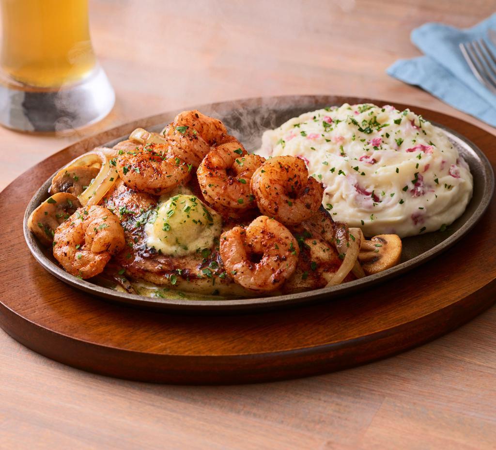 Bourbon Street Chicken & Shrimp · Cajun seasoned chicken and blackened shrimp jazzed up in garlic butter and parsley, with sizzling sautéed mushrooms and onions. Served with garlic mashed potatoes. Gluten-sensitive.