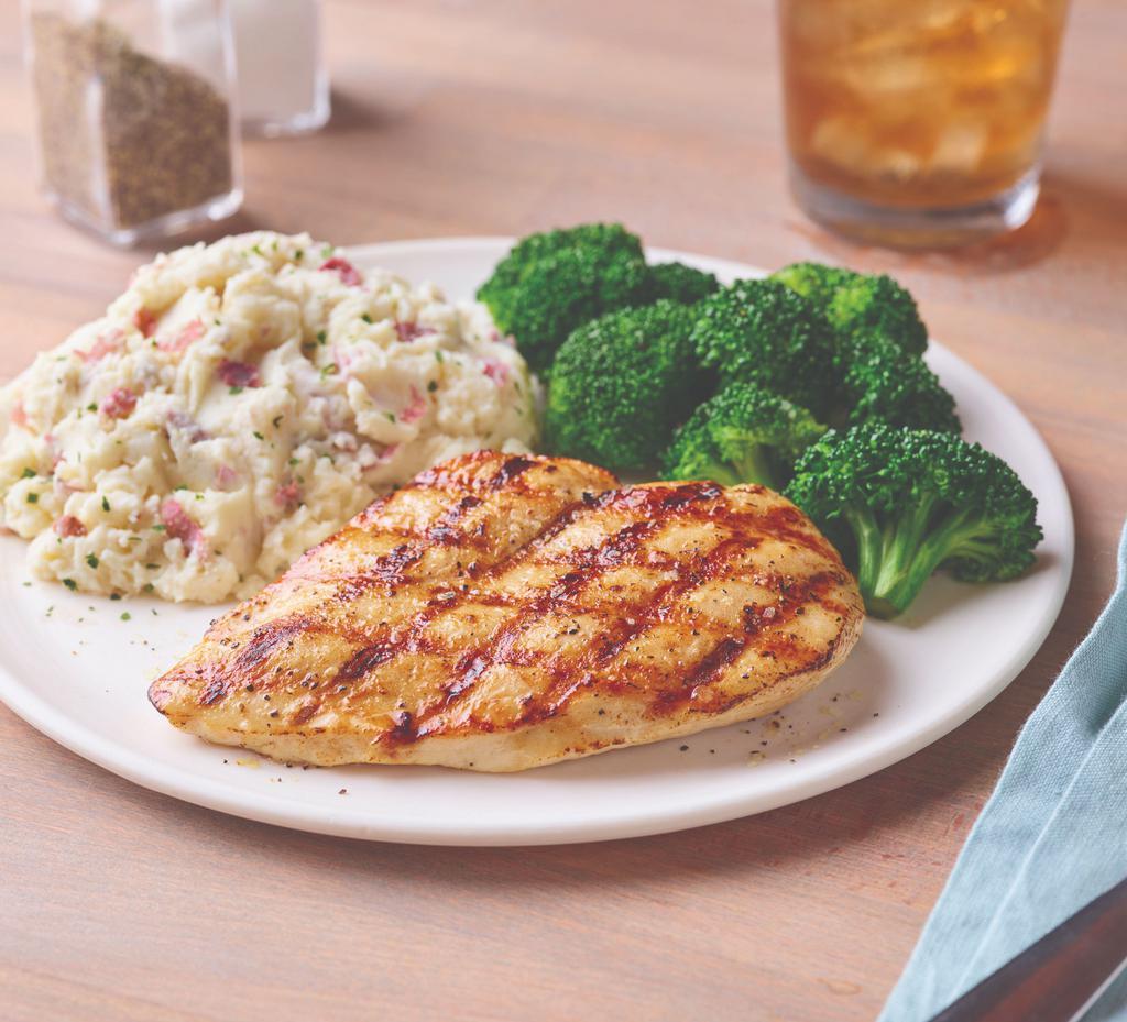 Grilled Chicken Breast · Juicy chicken breast seasoned and grilled over an open flame. Served with garlic mashed potatoes and broccoli. Gluten-sensitive.