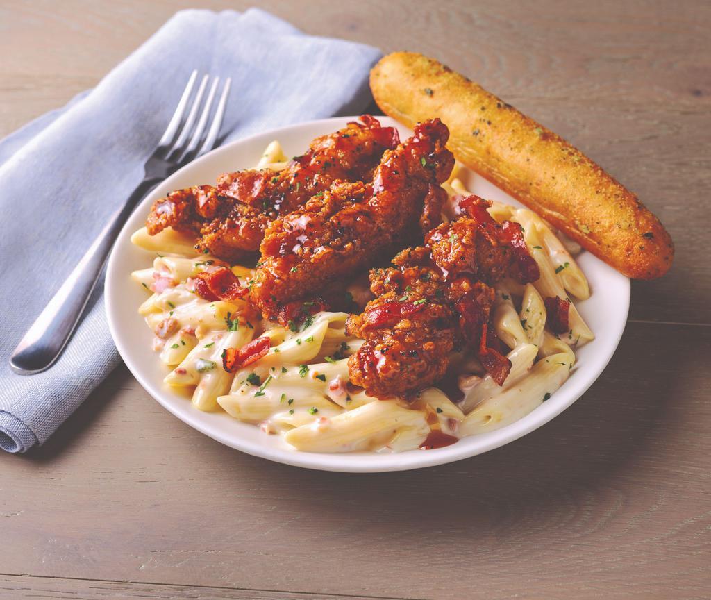 Four-Cheese Mac & Cheese with Honey Pepper Chicken Tenders · A sweet and savory take on comfort food, four-cheese Mac & Cheese is topped with crispy breaded chicken tenders tossed in honey pepper sauce and topped with bacon. Contains pork.