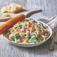 Classic Broccoli Chicken Alfredo · Juicy grilled chicken is served warm on a bed of fettuccine pasta tossed with broccoli and r...