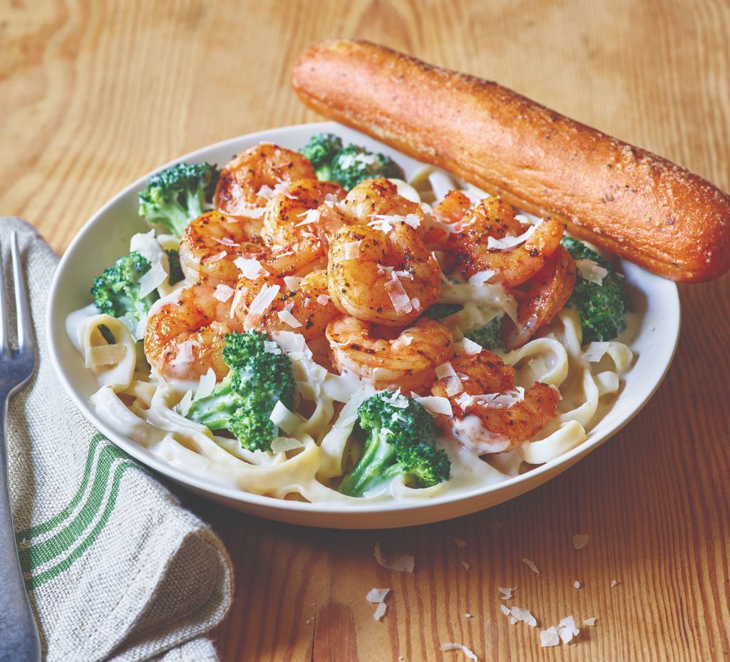 Classic Broccoli Shrimp Alfredo · Blackened shrimp is served warm on a bed of fettuccine pasta tossed with broccoli and rich Alfredo sauce topped with Parmesan cheese.