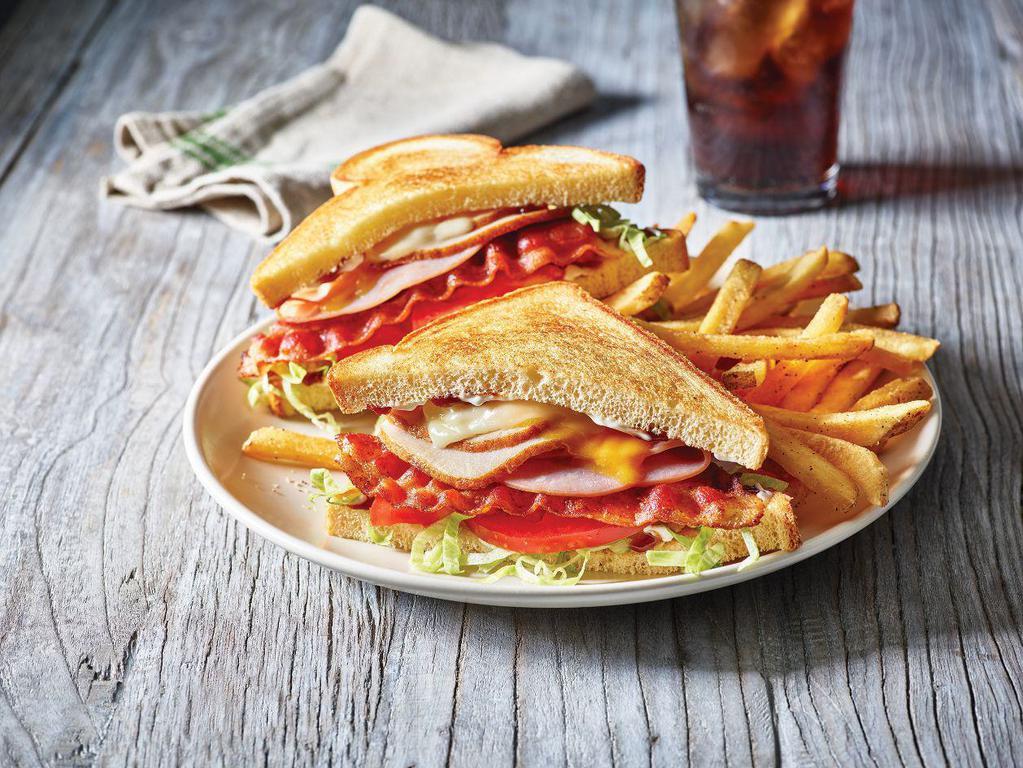 Clubhouse Grille · Turkey, ham, bacon, cheddar and Jack, honey BBQ, lettuce, tomato and mayo served on potato bread. Served with choice of side. 