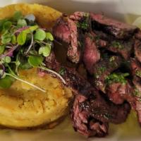 Mofongo Steak (hanger or skirt) · The steak is grilled to order, sliced, and then served over mofongo.