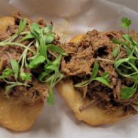 Arepa Ropa Vieja · Each order contains 2 arepas crowned with Cuban-style ropa vieja. Serves as a small appetize...