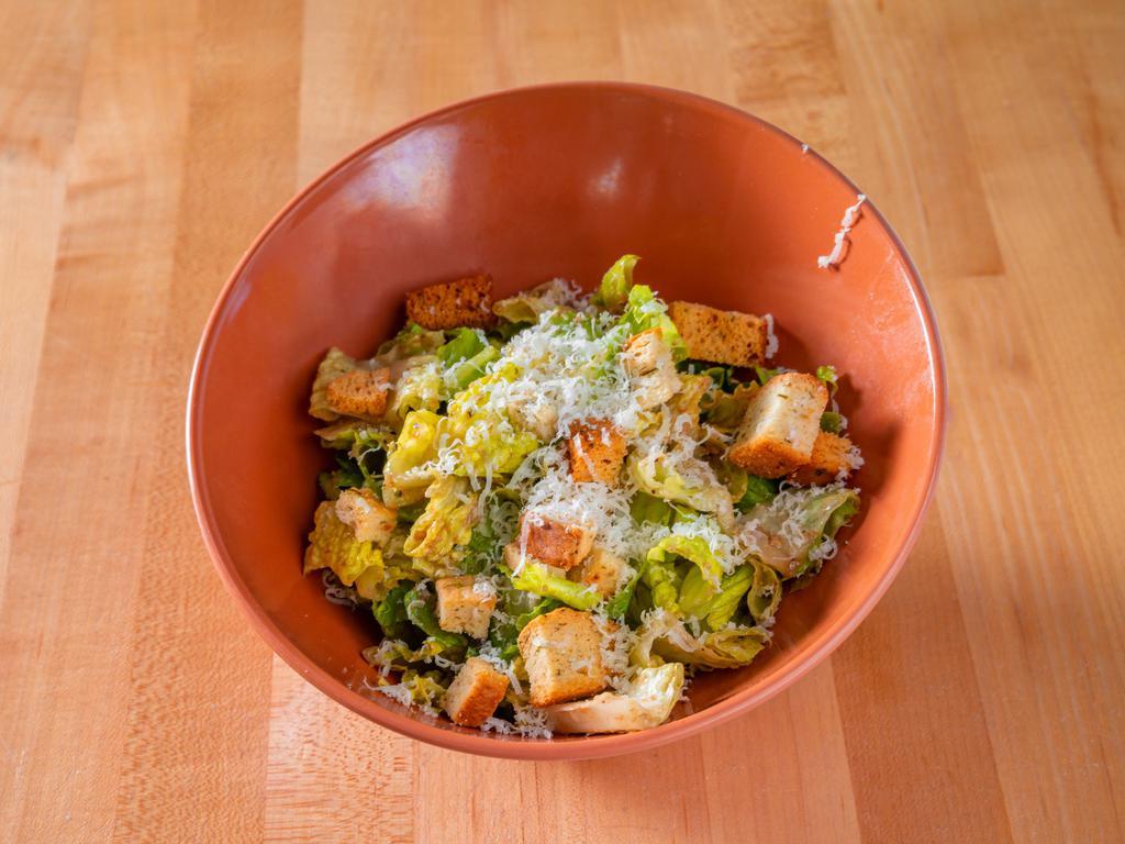 Classic Caesar Salad · Romaine lettuce tossed in house caesar dressing with house made croutons and fresh grated Parmigiano Reggiano.