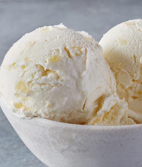 Pineapple Coconut Ice Cream · Let us take you on a voyage to a tropical island where exotic fruits ripen in the golden sun. We combine pure, sweet cream, tropical pineapple, and delectable coconut flavor for a truly indulgent ice cream experience. 

